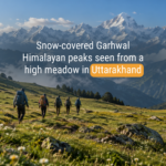 Trekking group walking across an open bugyal meadow in Uttarakhand